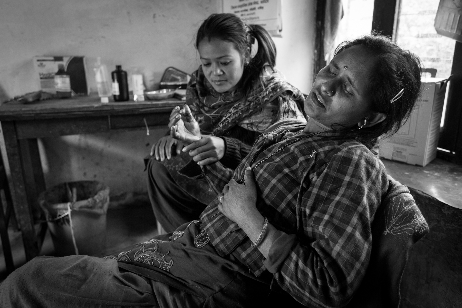 Chanamati Maggrati is being treated at her nearest health post, a 5-hour walk through the mountains. 18 December 2013, Dhading, Nepal.