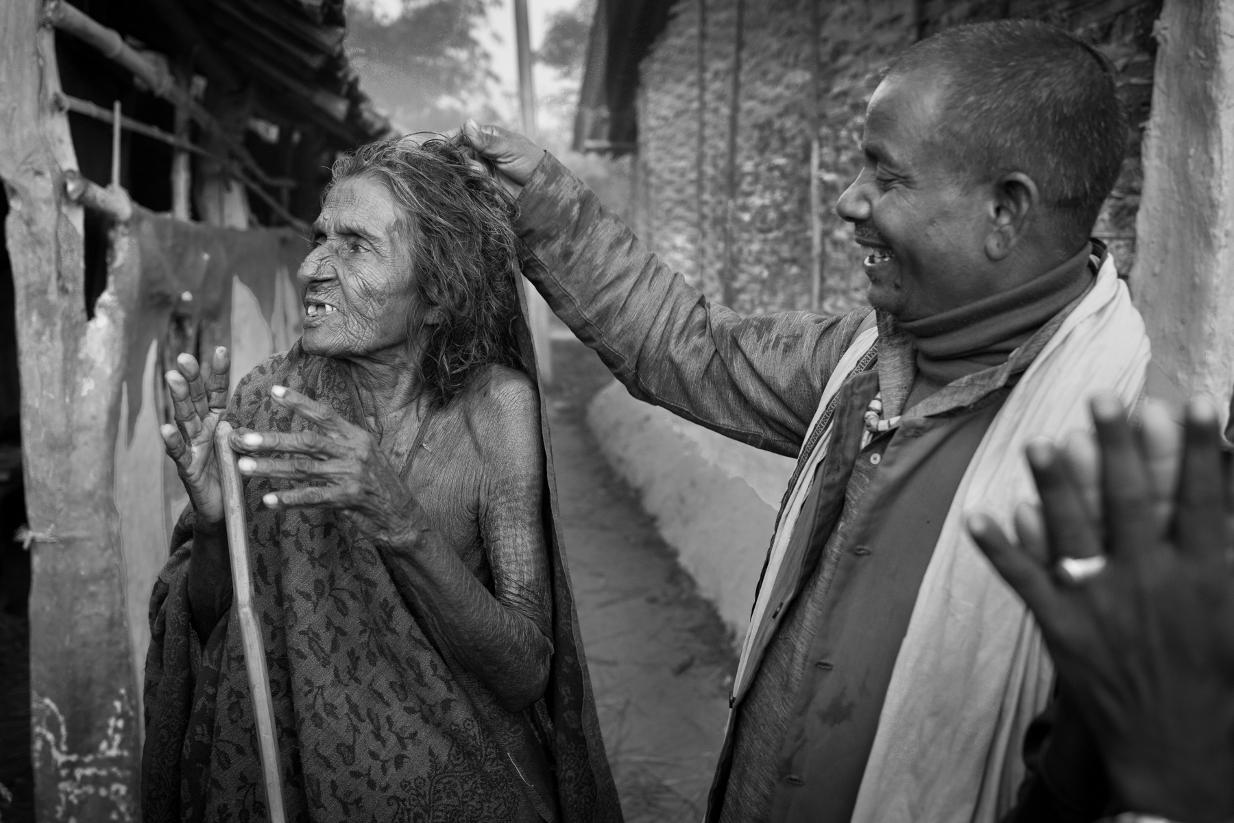 A dhami humiliates Kanti Yadav, 103, as he accuses her of being a witch. 5 November 2014, Dhanusha, Nepal.