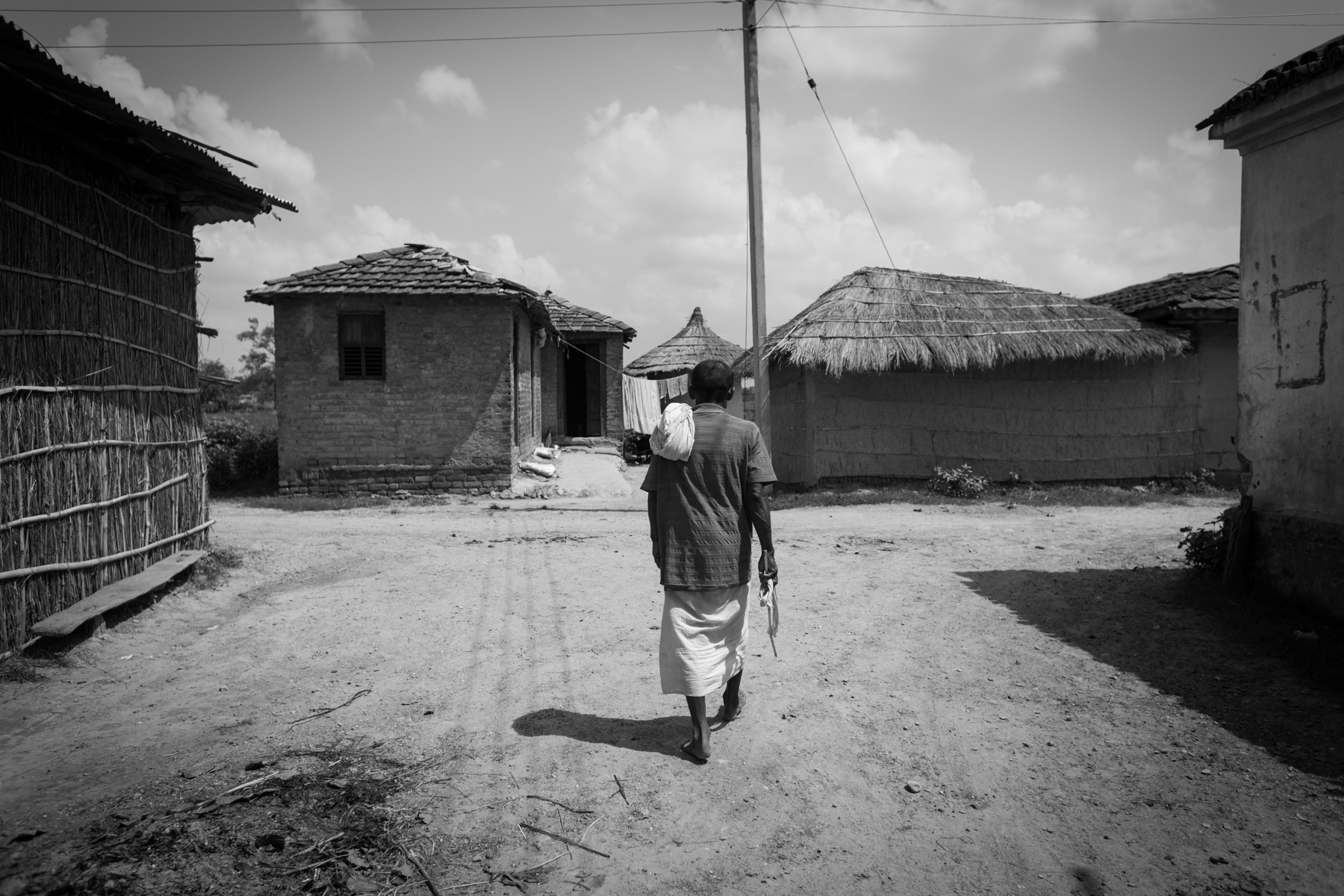Bhagan Chaudhary walks towards the crossroad where his wife was killed. 24 August 2013, Supauli, Parsa, Nepal.